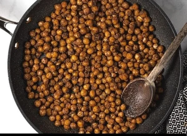 A plate of 20-minute vegan chickpea tacos topped with fresh ingredients and lime.