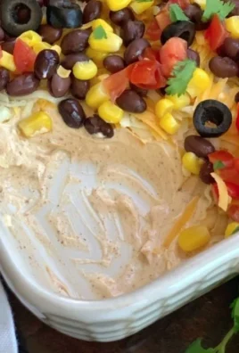 Delicious 7 Layer Taco Dip served in a bowl, perfect for parties and gatherings.