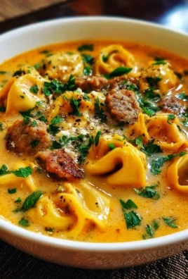 Creamy butternut squash soup with sausage and tortellini in a bowl