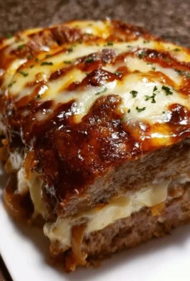 Delicious French onion soup meatloaf topped with melted Swiss cheese