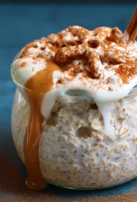 Bowl of easy cinnamon roll overnight oats with spices and toppings