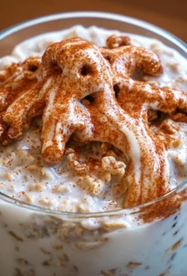 Bowl of easy cinnamon roll overnight oats topped with walnuts and cinnamon