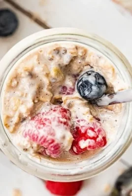 Bowl of low calorie overnight oats topped with fresh fruits and nuts