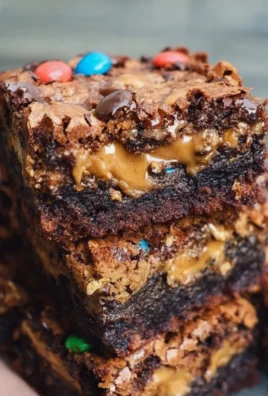 Delicious Monster Cookie Brownies topped with colorful sprinkles and chocolate chips.