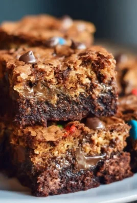 Delicious Monster Cookie Fudgy Brownies topped with colorful candies and chocolate chips