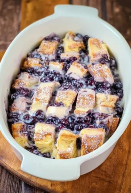 Delicious Overnight Blueberry French Toast Casserole served with syrup.