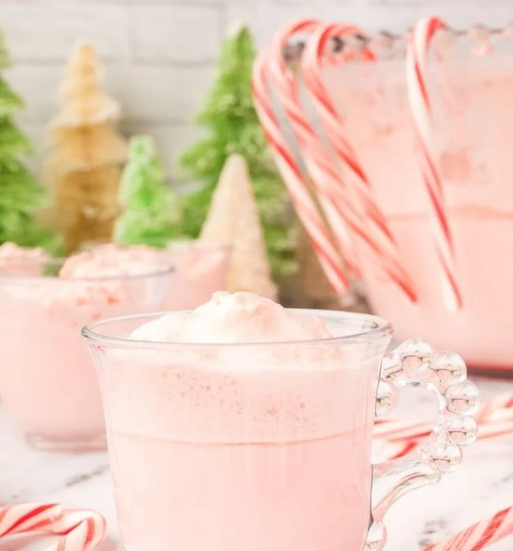Refreshing Peppermint Eggnog Punch served in a festive glass with mint leaves.