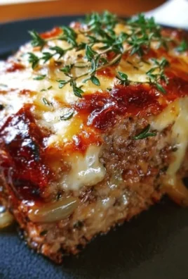 Delicious meatloaf topped with caramelized onions and melted cheese