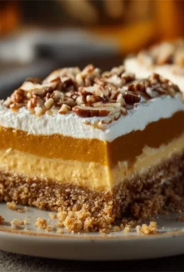 Delicious Pumpkin Lush dessert garnished with whipped cream.