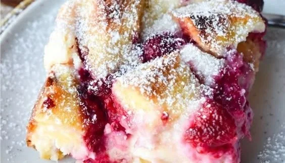 Raspberry Cheesecake French Toast Casserole with fresh raspberries and cream cheese