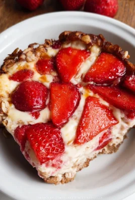 Baked oatmeal topped with fresh strawberries and cheesecake flavors