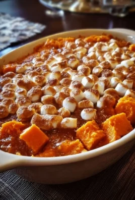 Delicious sweet potato casserole topped with marshmallows and pecans